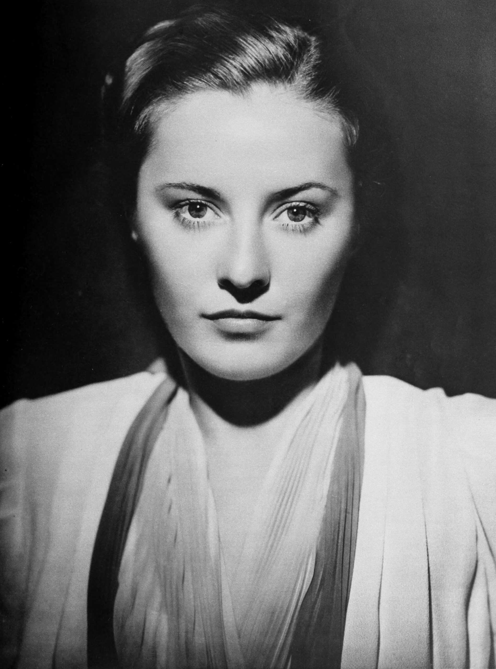 Black-and-white head-and-shoulders portrait of Barbara Stanwyck photographed by George Hurrell in 1938.