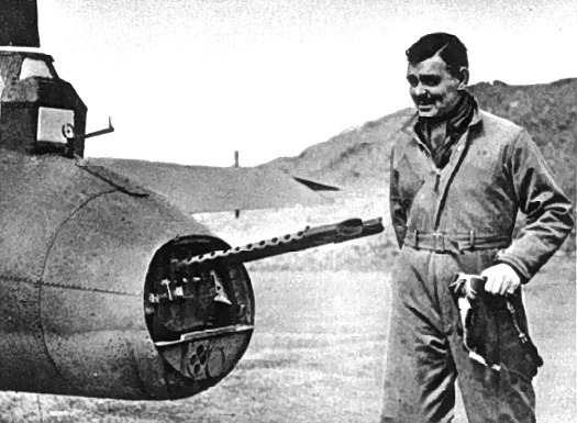 Clark Gable in flying clothes standing beside a military aircraft while serving with the Eighth Air Force in Britain in 1943.
