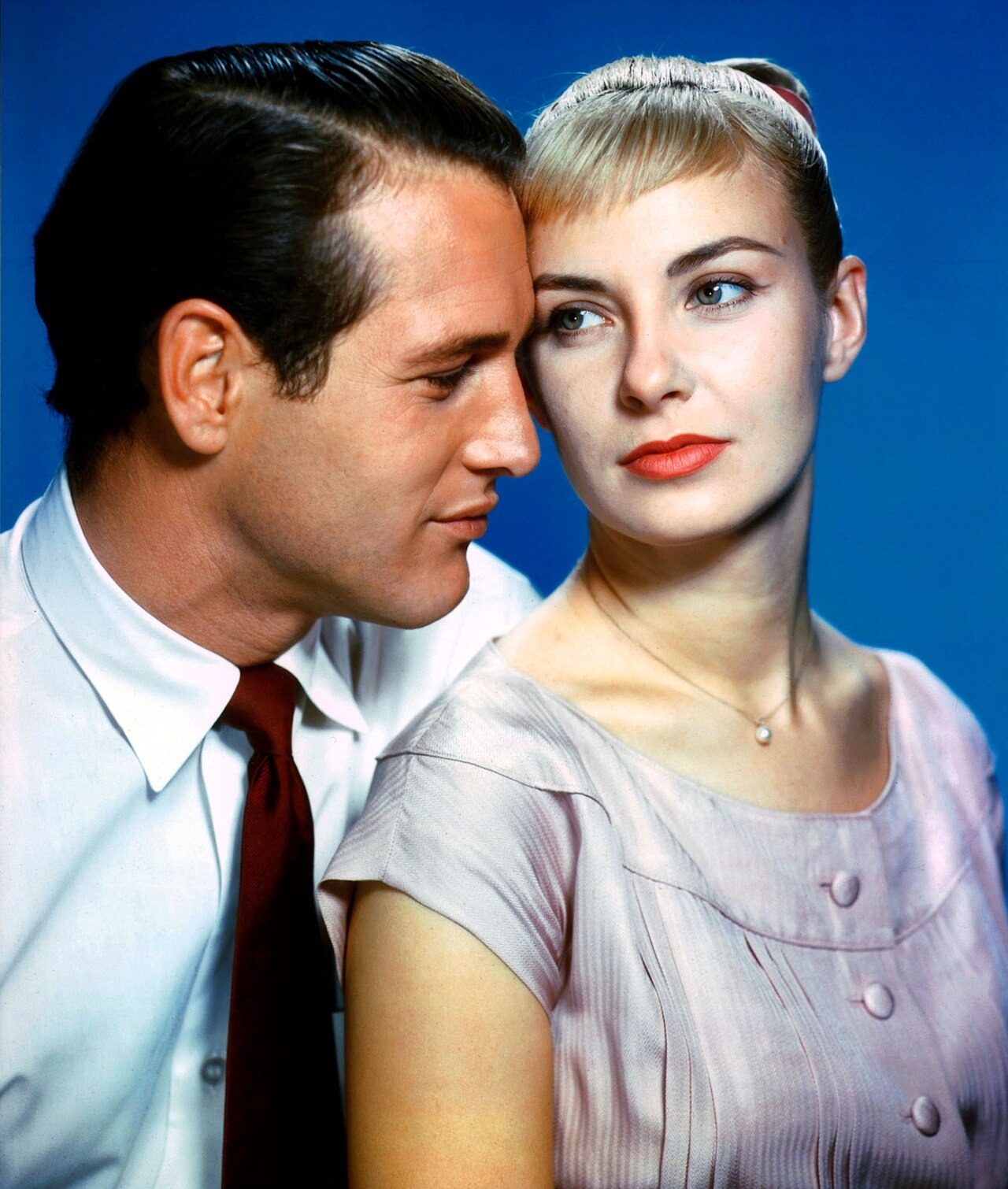 Paul Newman leans toward Joanne Woodward in a colour publicity portrait for The Long, Hot Summer.