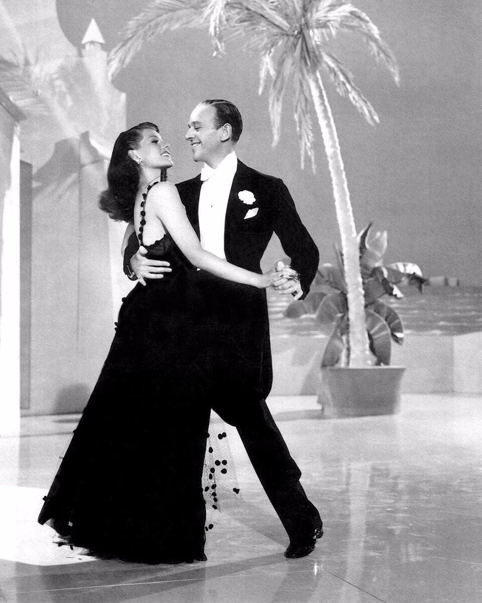 Rita Hayworth and Fred Astaire dancing together in a black-and-white publicity image for You’ll Never Get Rich.
