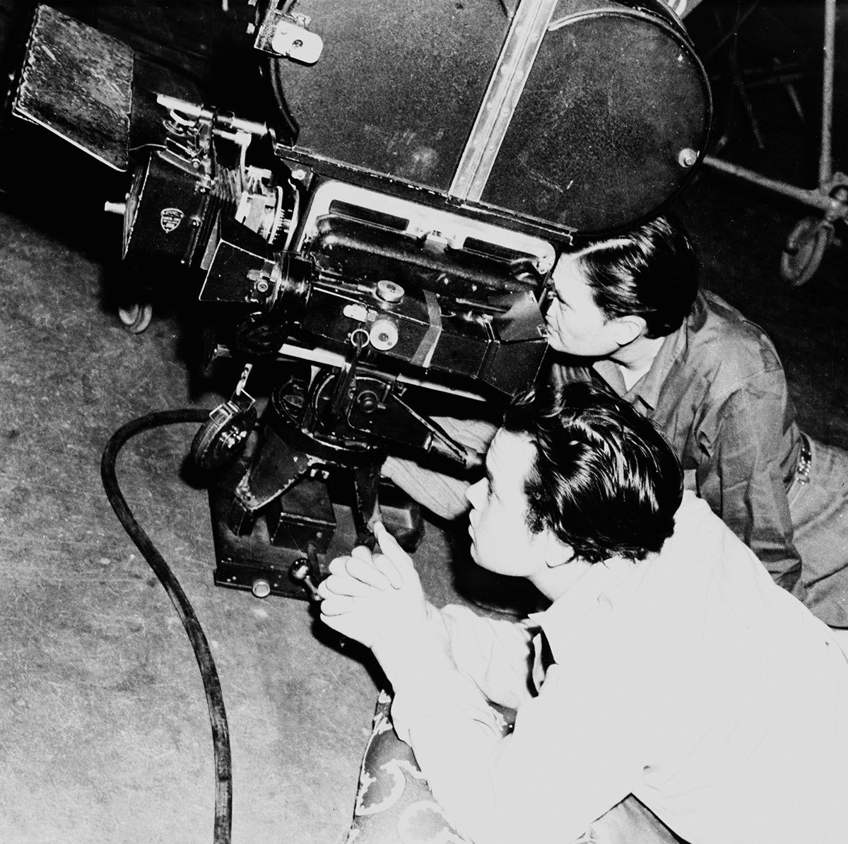 Orson Welles and cinematographer Gregg Toland working beside a movie camera during Citizen Kane.
