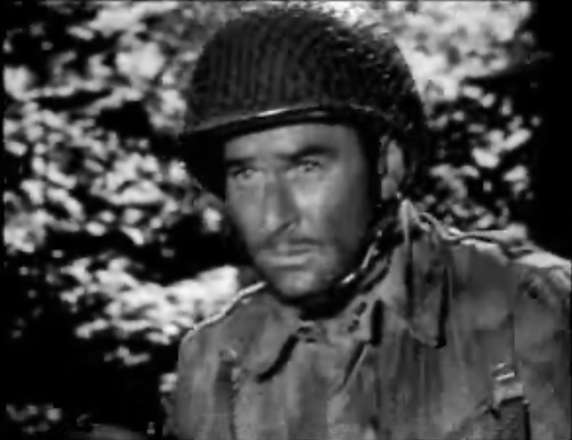 Errol Flynn wears military uniform in a black-and-white trailer image from Objective, Burma!