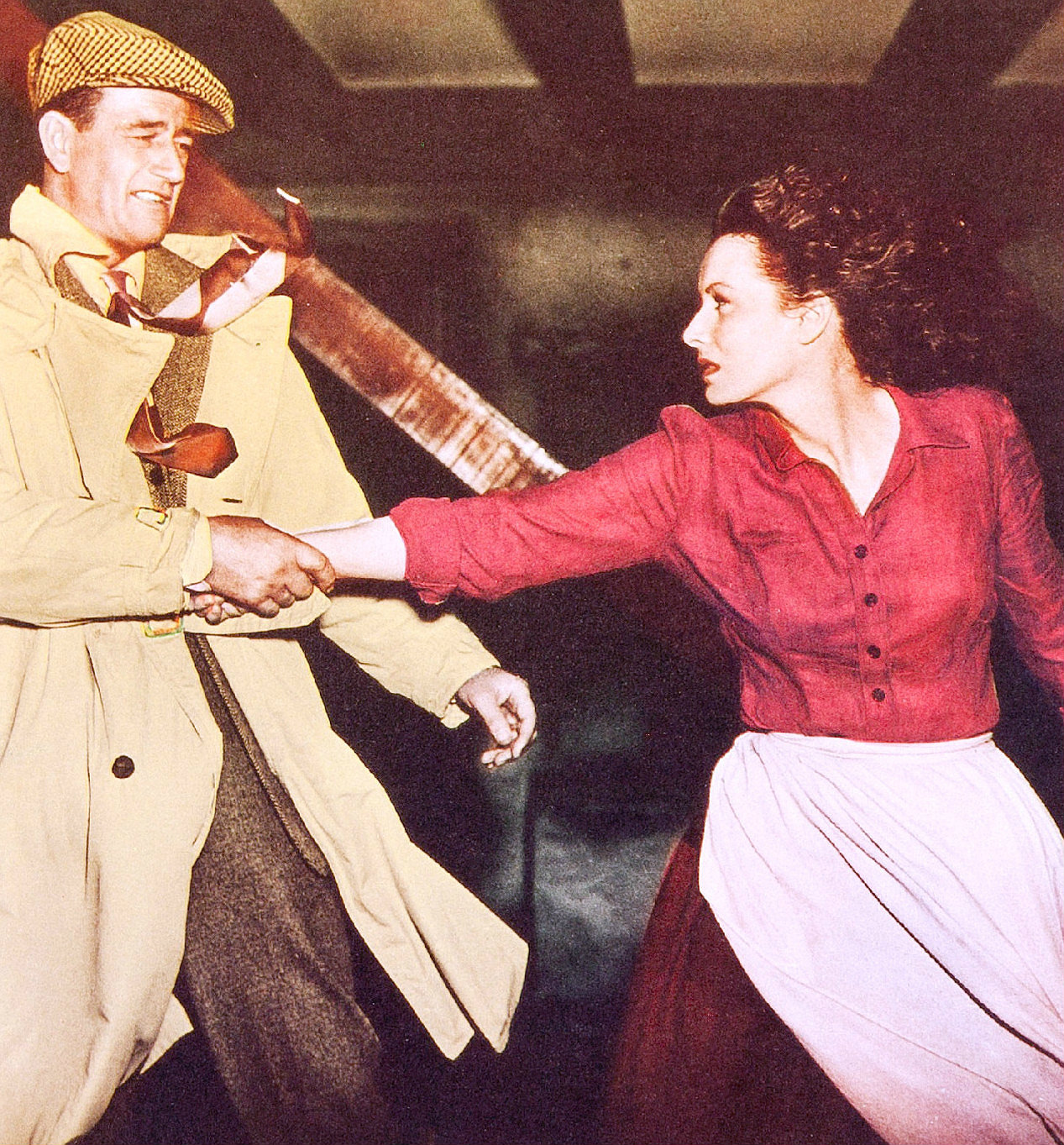 John Wayne and Maureen O’Hara face one another in a colour lobby-card image for The Quiet Man.