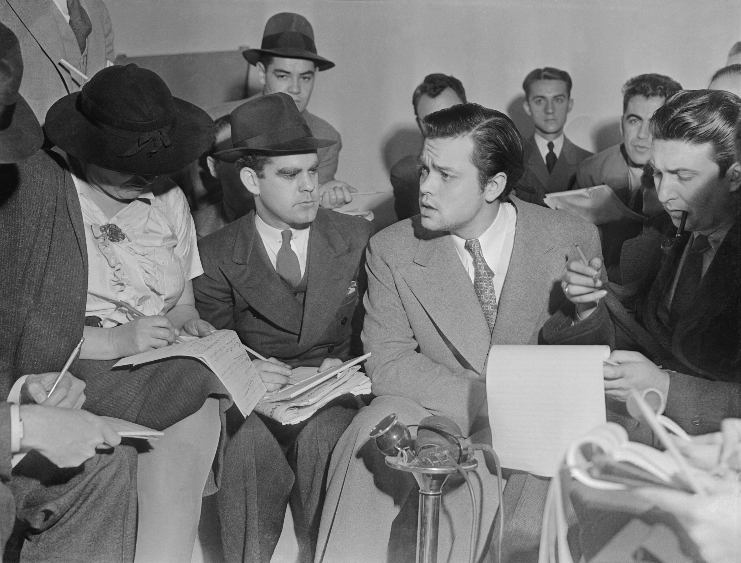 Orson Welles seated at a press conference after the War of the Worlds radio broadcast in 1938.