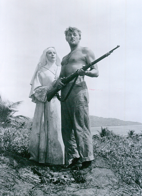 Black-and-white publicity photograph of Robert Mitchum in military clothing beside Deborah Kerr in a nun's habit.