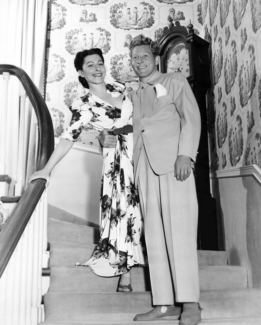 Sylvia Fine and Danny Kaye smile together in a black-and-white magazine photograph from 1945.