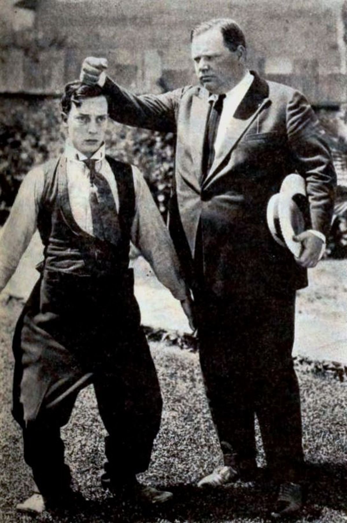 Actors Buster Keaton and Roscoe Arbuckle having fun on the studio lot, on page 83 of the November 20, 1920 Exhibitors Herald.